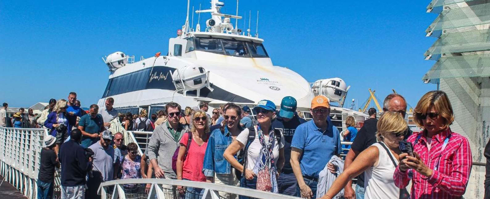 Tourists disembarking from the Robben Island Ferry at the V&A Waterfront.